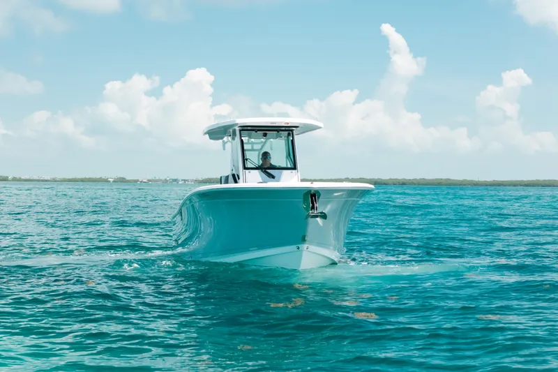 Slide: The Image of 2023 Blackfin 272 CC boat cruising on clear blue ocean under a bright sky. - 44