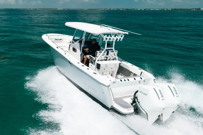 The Image of 2023 Blackfin 272 CC boat cruising on clear blue ocean waters. - 0
