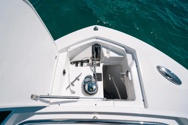 Slide: The Image of Anchor compartment of 2023 Blackfin 272 CC boat on clear blue water. - 32