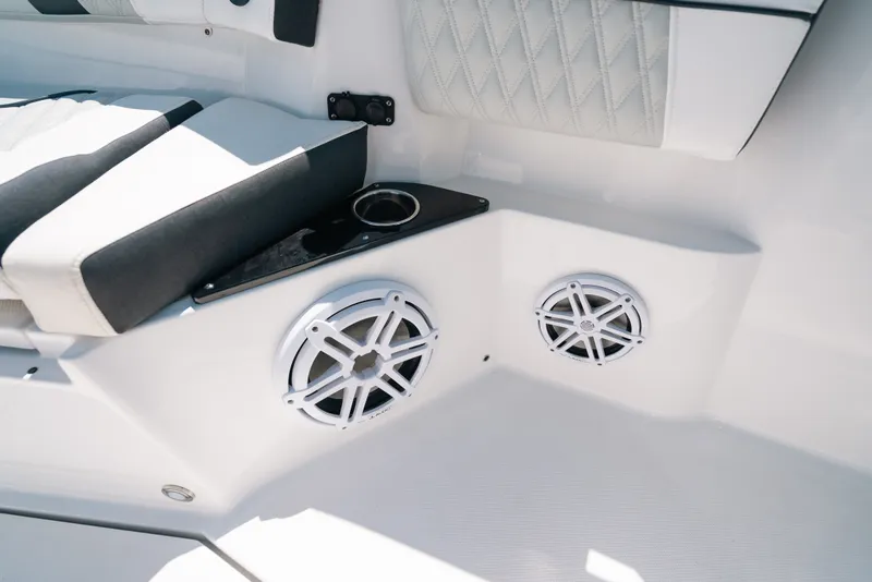 Slide: The Image of 2023 Blackfin 272 CC boat interior with speakers and cushioned seating. - 68