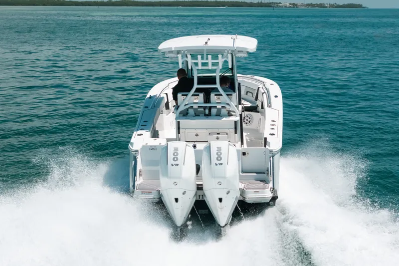 Slide: The Image of 2023 Blackfin 272 CC boat cruising on open water, rear view. - 3