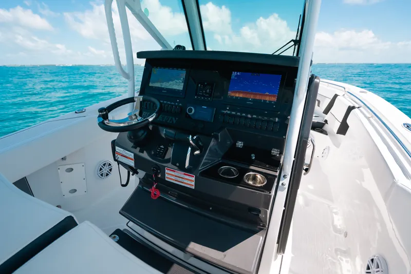 Slide: The Image of 2023 Blackfin 272 CC boat cockpit with advanced navigation system on open water. - 23