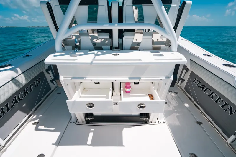 Slide: The Image of 2023 Blackfin 272 CC boat interior with storage compartments open on a sunny day. - 108