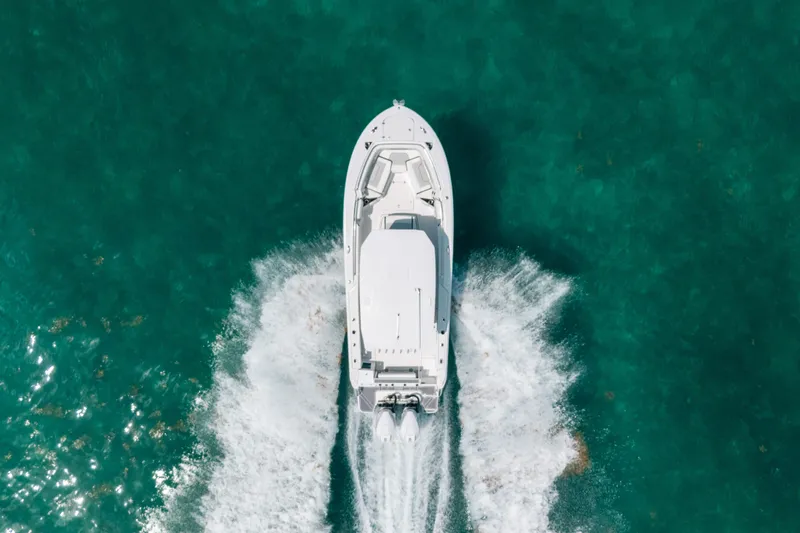 Slide: The Image of Aerial view of 2023 Blackfin 272 CC boat cruising on turquoise water. - 8