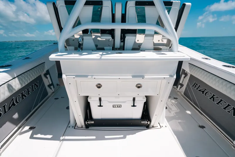 Slide: The Image of 2023 Blackfin 272 CC boat interior with seating and storage, featuring a Yeti cooler. - 109
