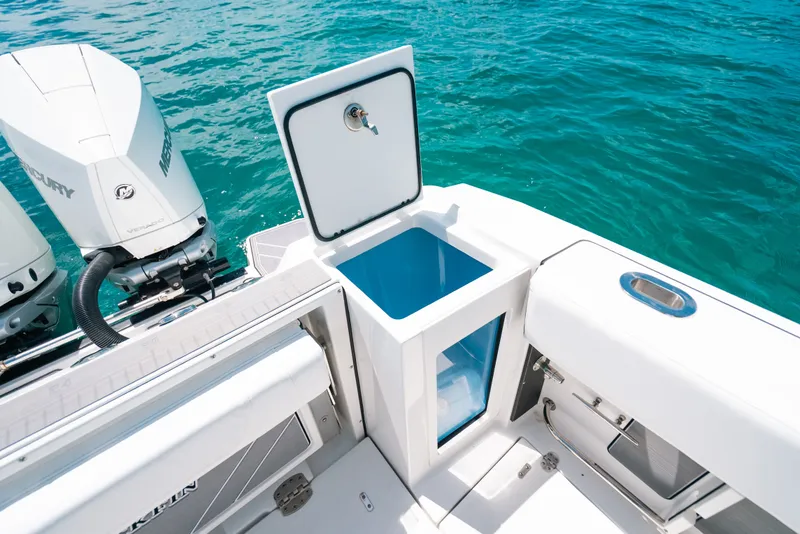 Slide: The Image of 2023 Blackfin 272 CC boat with open storage compartment and twin Mercury engines. - 47