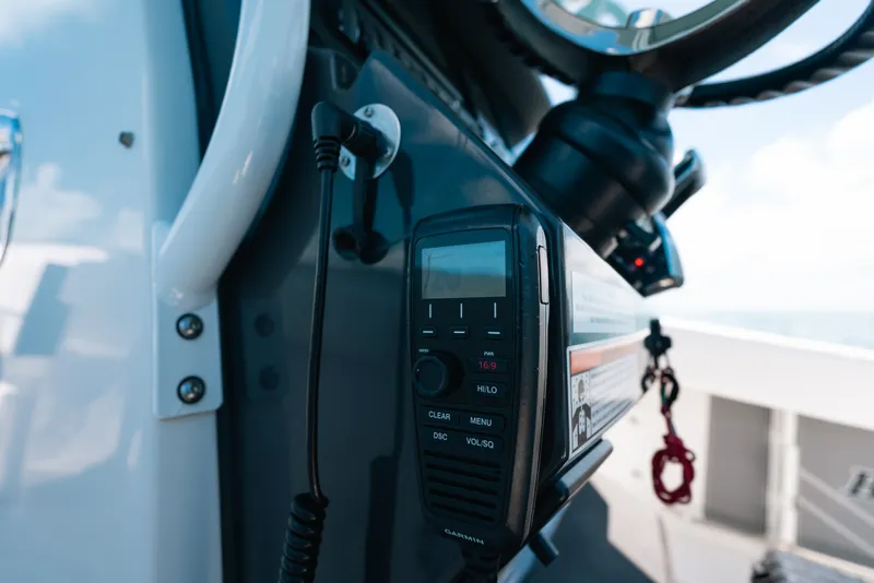 Slide: The Image of Close-up of a 2023 Blackfin 272 CC boat's control panel with a Garmin radio. - 52