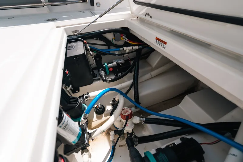 Slide: The Image of 2023 Blackfin 272 CC boat engine compartment with wiring and components. - 55