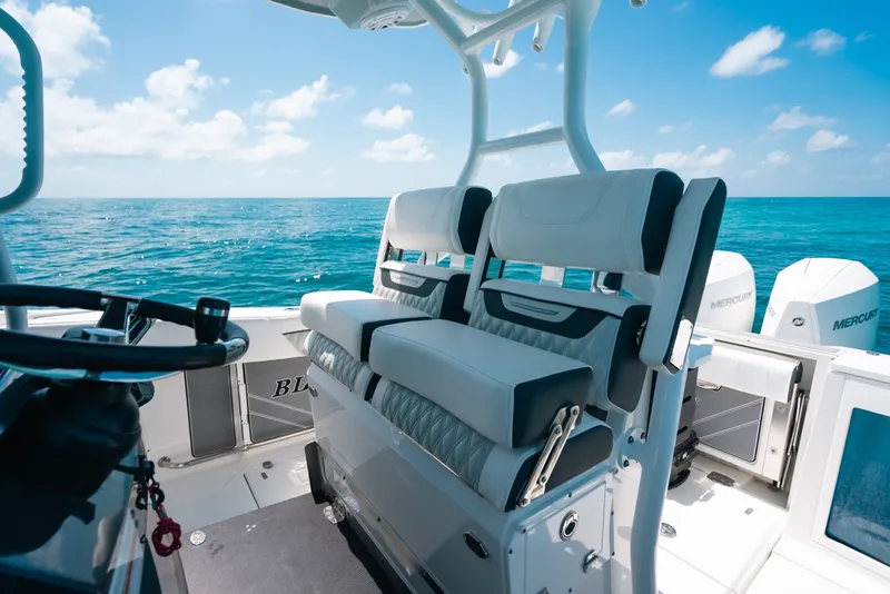 Slide: The Image of 2023 Blackfin 272 CC boat interior with ocean view and dual Mercury engines. - 14