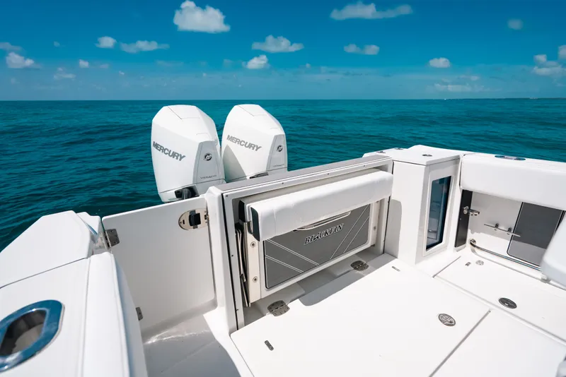 Slide: The Image of 2023 Blackfin 272 CC boat with twin Mercury engines on open sea. - 13