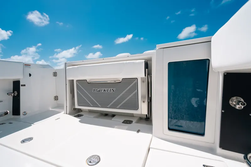 Slide: The Image of 2023 Blackfin 272 CC boat interior with sleek design under clear blue sky. - 58