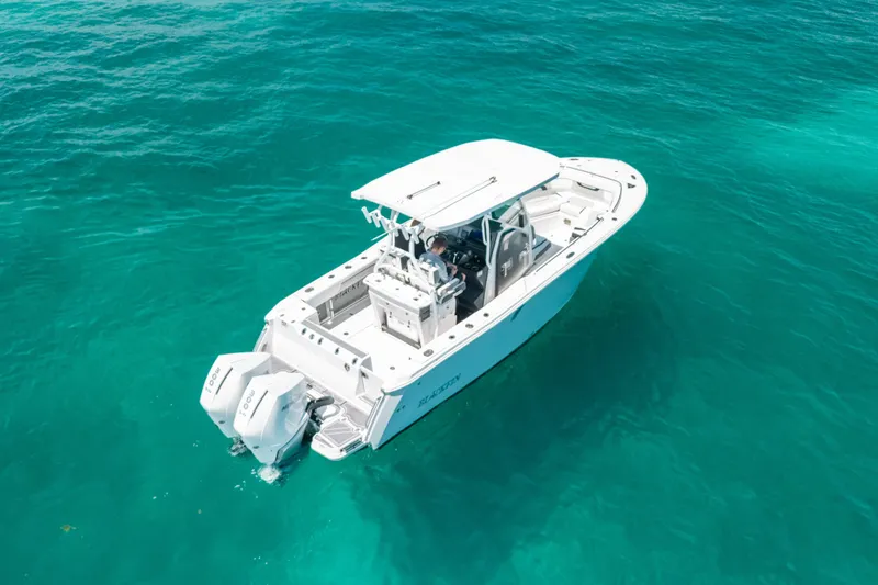 Slide: The Image of 2023 Blackfin 272 CC boat cruising on clear turquoise water. - 10