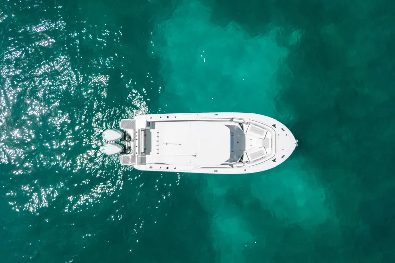 Slide: The Image of Aerial view of 2023 Blackfin 272 CC boat on turquoise water. - 81