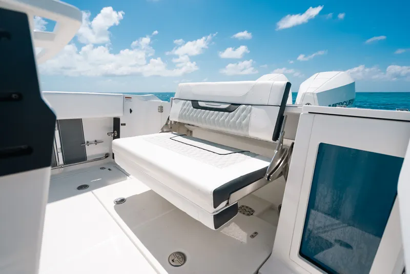 Slide: The Image of 2023 Blackfin 272 CC boat interior with white seating, ocean view, and blue sky. - 103