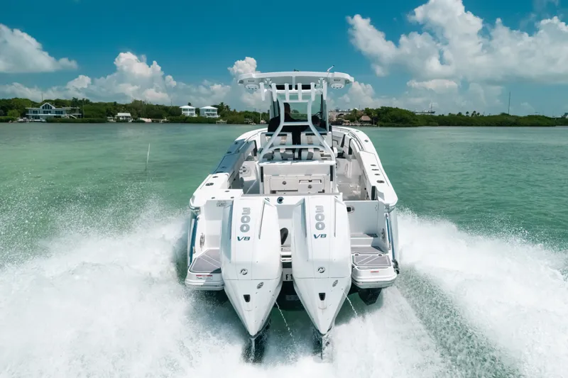 Slide: The Image of 2023 Blackfin 272 CC boat cruising on clear turquoise water under a blue sky. - 1