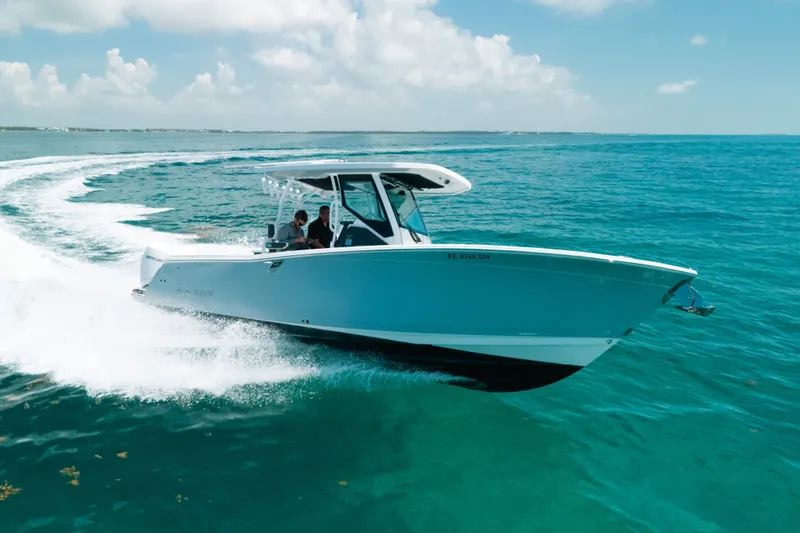 Slide: The Image of 2023 Blackfin 272 CC cruising on clear blue ocean waters. - 95