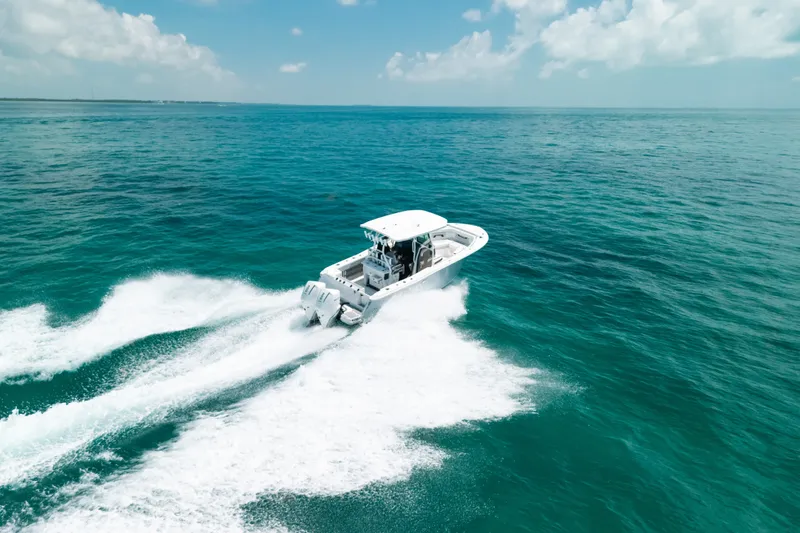 Slide: The Image of 2023 Blackfin 272 CC cruising on open ocean under clear skies. - 77