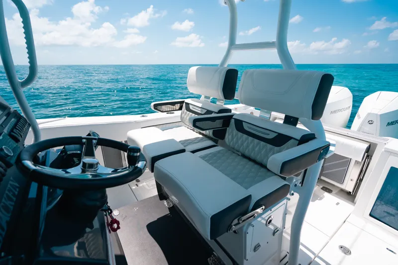 Slide: The Image of 2023 Blackfin 272 CC boat interior with dual seats and ocean view. - 15