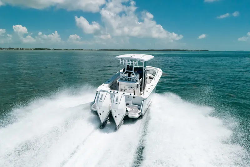 Slide: The Image of 2023 Blackfin 272 CC boat cruising on open water under a clear blue sky. - 2