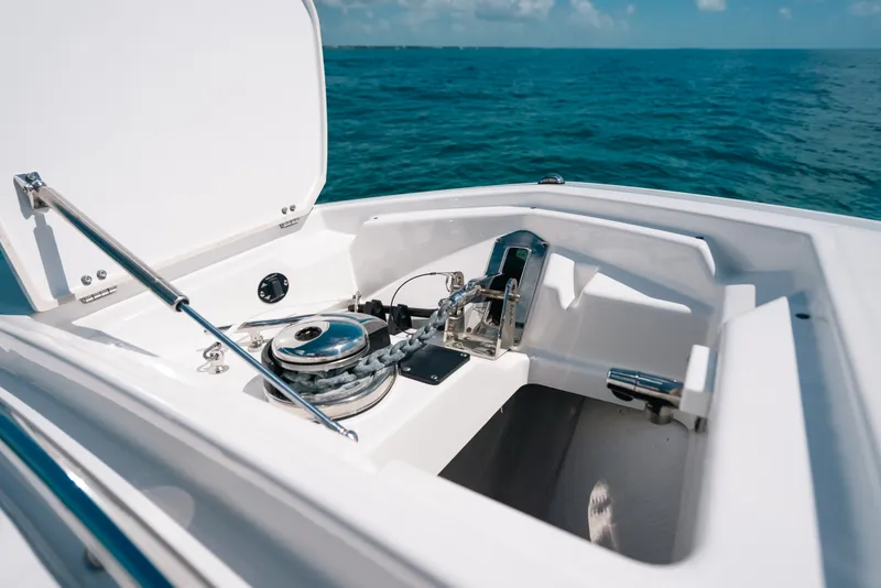 Slide: The Image of 2023 Blackfin 272 CC boat anchor compartment with ocean backdrop. - 31
