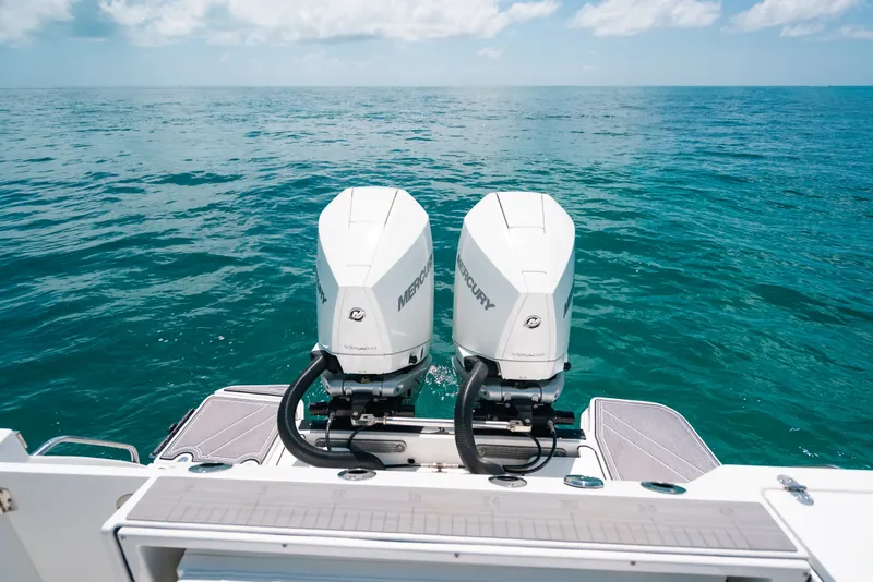 Slide: The Image of 2023 Blackfin 272 CC boat with dual Mercury outboard engines on open sea. - 46
