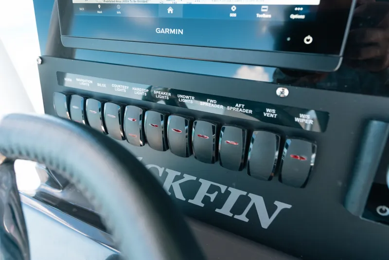 Slide: The Image of Control panel of 2023 Blackfin 272 CC boat with labeled switches and Garmin display. - 65