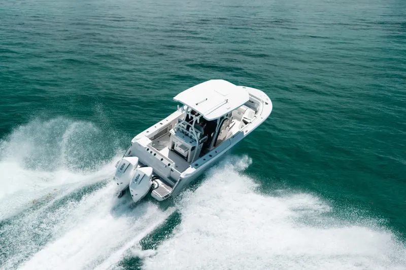 Slide: The Image of 2023 Blackfin 272 CC boat cruising on open water, showcasing powerful dual engines. - 5