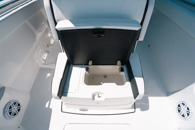 Slide: The Image of 2023 Blackfin 272 CC boat seat with storage compartment open. - 26