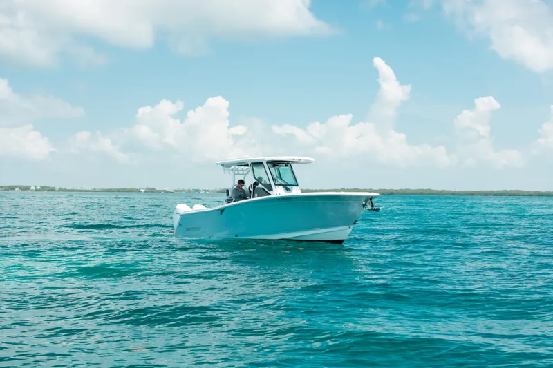 Slide: The Image of 2023 Blackfin 272 CC boat cruising on clear blue ocean under a bright sky. - 91