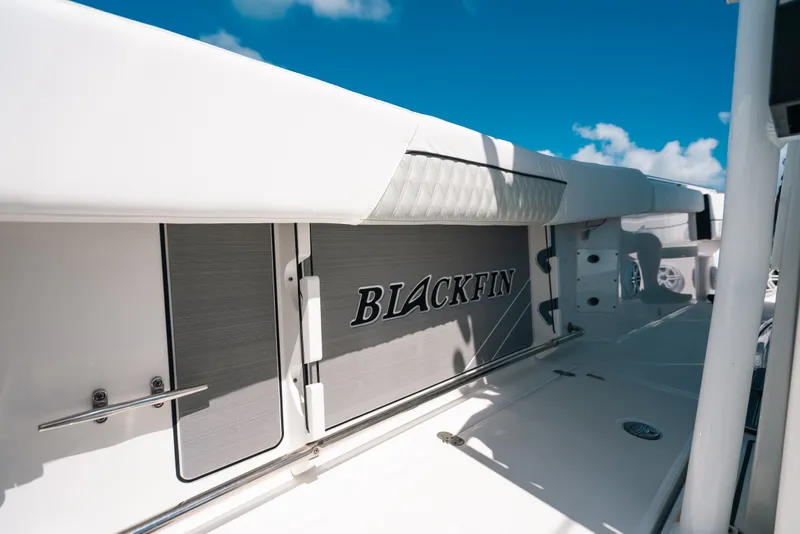 Slide: The Image of 2023 Blackfin 272 CC boat deck with sleek design under clear blue sky. - 105