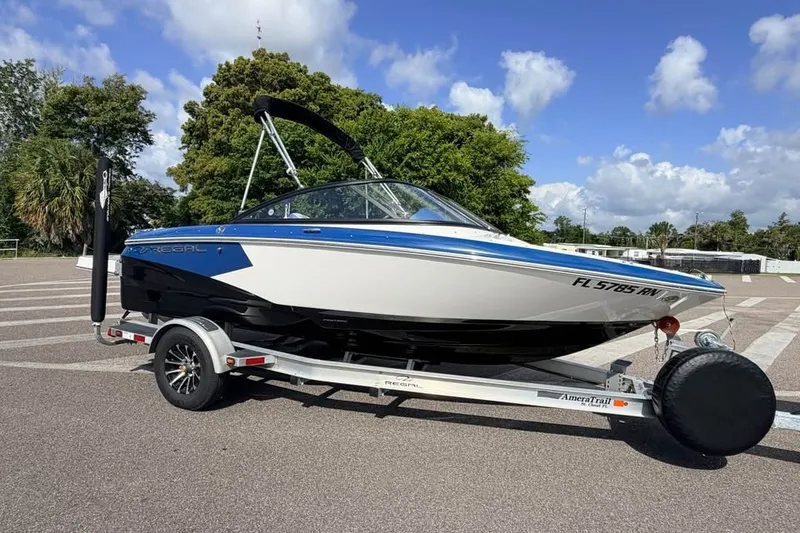 The Image of 2018 Regal 1900 ESX Bowrider on trailer, parked outdoors under a clear sky. - 0