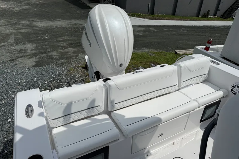 Slide: The Image of 2027 Sportsman Heritage 231 Center Console boat with white seating and Yamaha engine. - 16