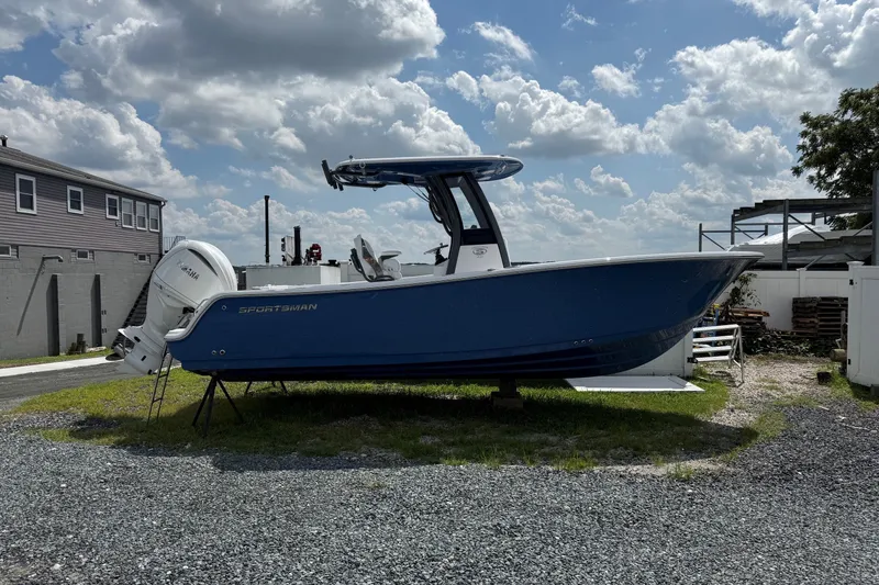 The Image of 2027 Sportsman Heritage 231 Center Console boat on display under a cloudy sky. - 1