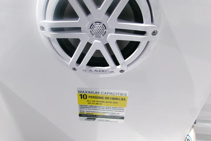 Slide: The Image of Speaker and capacity label on 2027 Sportsman Open 232 Center Console boat. - 13