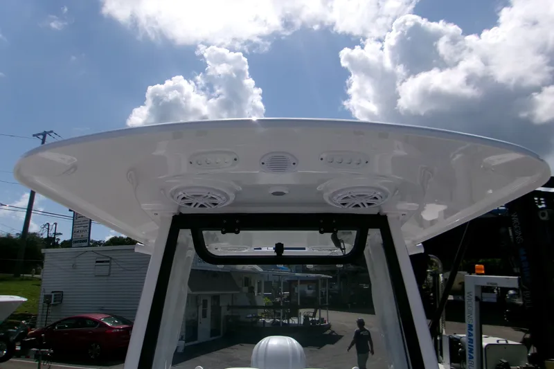 Slide: The Image of 2027 Sportsman Open 232 Center Console boat with speakers and lights under a clear sky. - 12