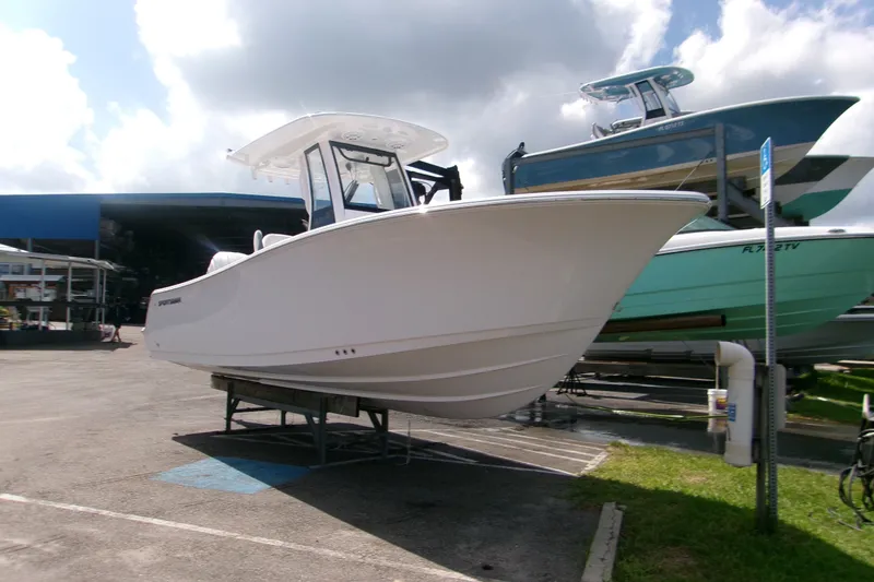 The Image of 2027 Sportsman Open 232 Center Console boat displayed outdoors on a sunny day. - 0