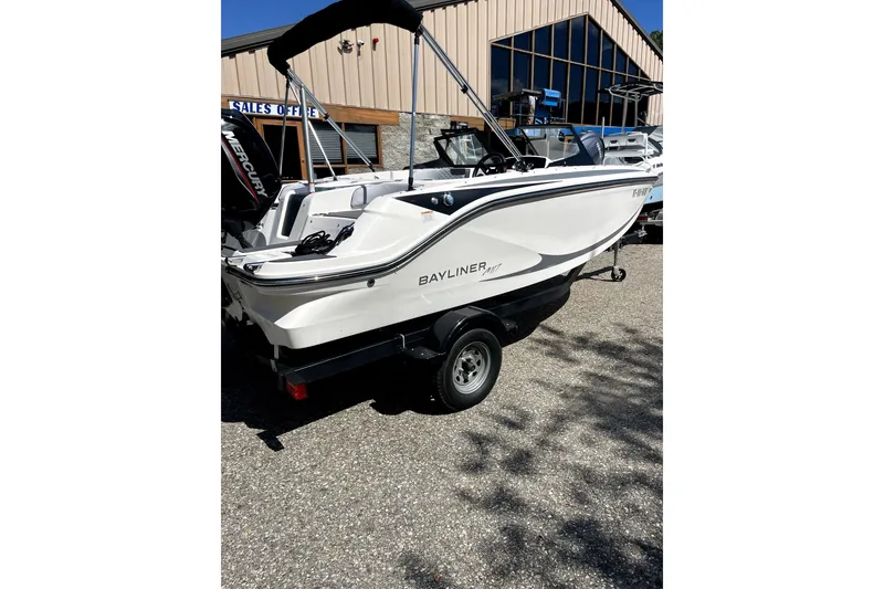 Slide: The Image of 2024 Bayliner Element M17 boat on trailer, displayed outdoors near sales office. - 1