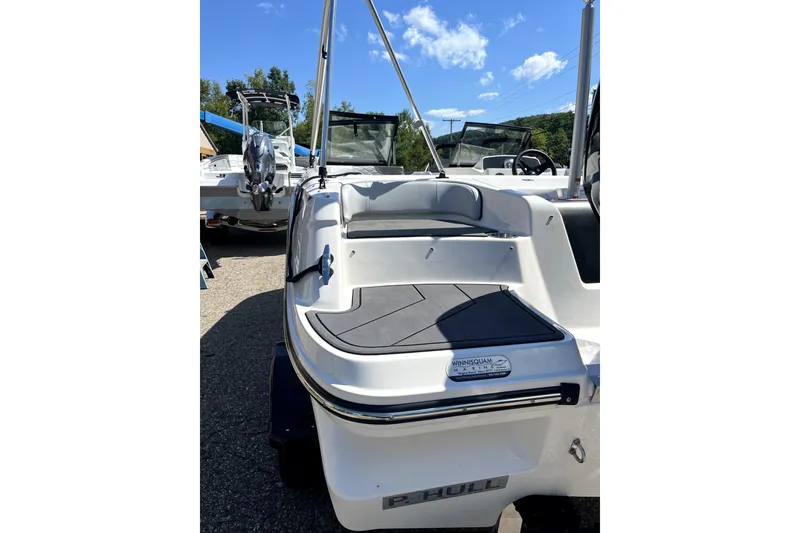 Slide: The Image of 2024 Bayliner Element M17 boat rear view with seating and motor, outdoors. - 15