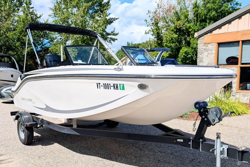 Slide: The Image of 2024 Bayliner Element M17 boat on trailer, parked outdoors, sunny day. - 0