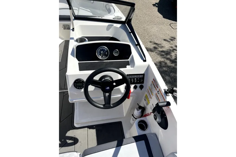 Slide: The Image of 2024 Bayliner Element M17 boat dashboard with steering wheel and controls. - 9