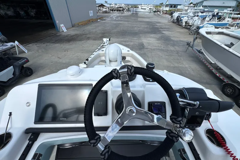 Slide: The Image of Cockpit view of 2026 Solace 32CS boat with modern steering and navigation system. - 26