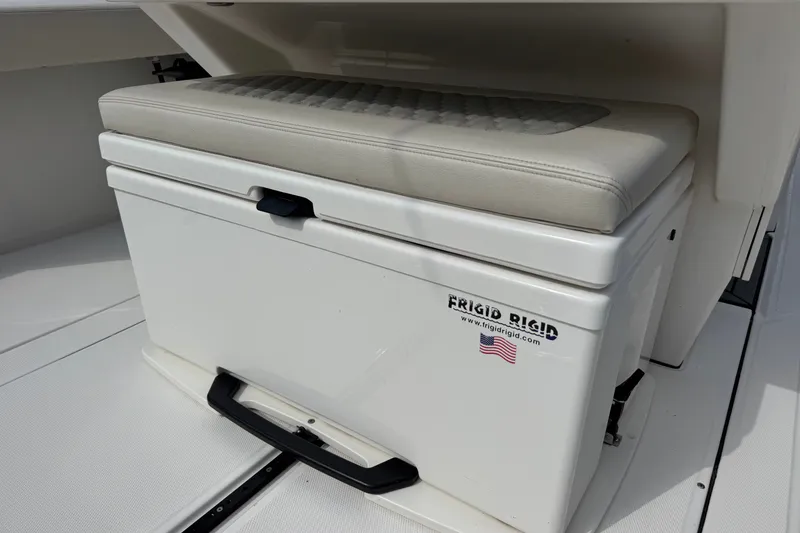 Slide: The Image of Cushioned storage seat on 2026 Solace 32CS boat, featuring Frigid Rigid cooler. - 12