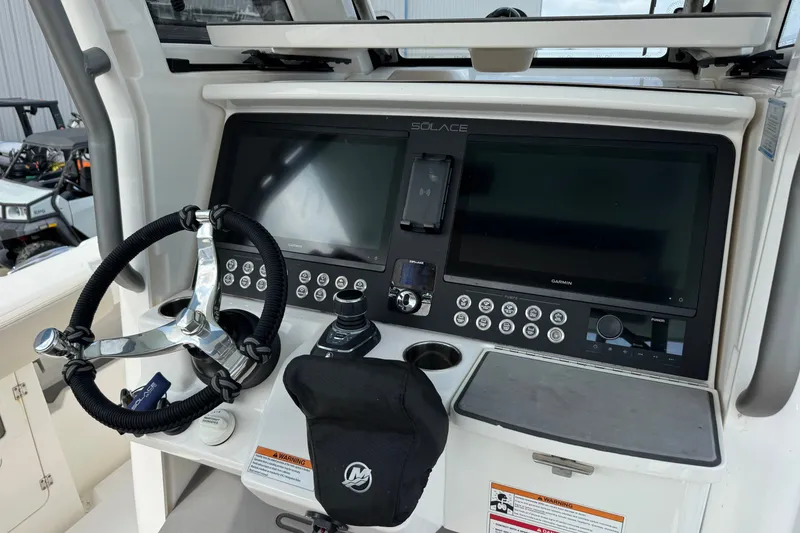 Slide: The Image of Helm of 2026 Solace 32CS boat with advanced navigation controls and displays. - 16