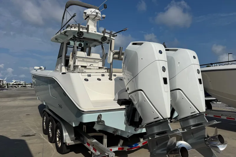 Slide: The Image of 2026 Solace 32CS boat with dual outboard engines on a trailer. - 5