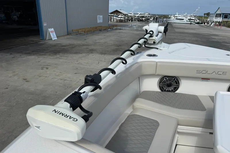 Slide: The Image of 2026 Solace 32CS boat interior with Garmin equipment, featuring cushioned seating and speaker system. - 21