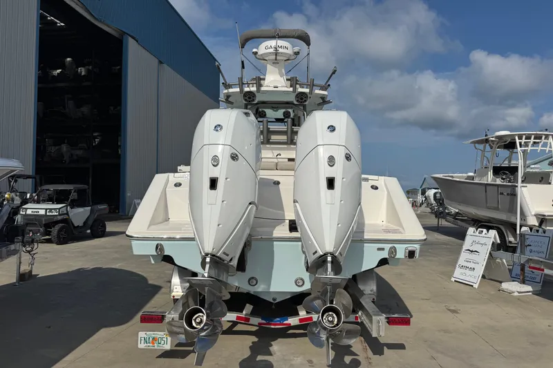 Slide: The Image of 2026 Solace 32CS boat with dual outboard engines at a marina. - 4