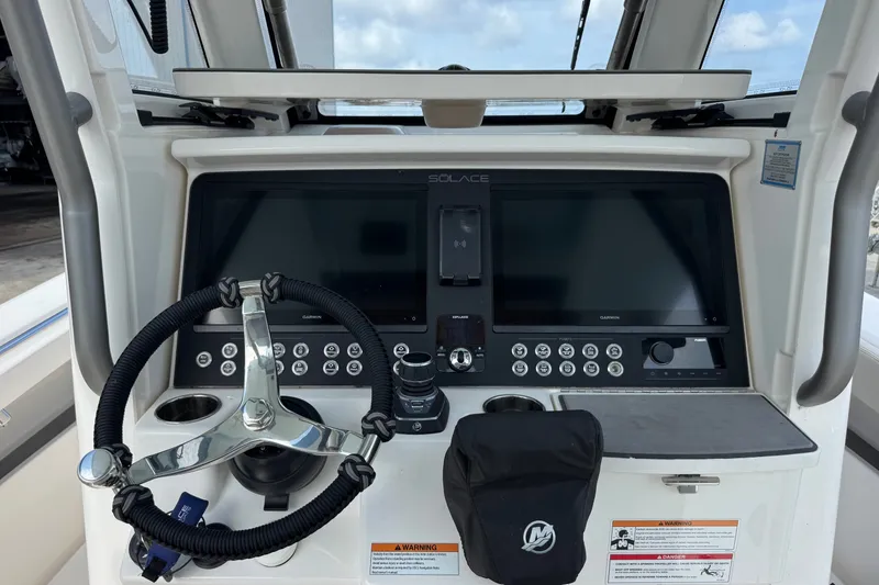 Slide: The Image of Helm of 2026 Solace 32CS boat with advanced navigation controls and steering wheel. - 18