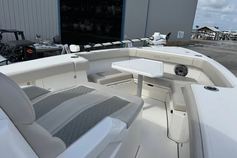 Slide: The Image of Luxurious 2026 Solace 32CS boat interior with seating and table, docked near a marina. - 20