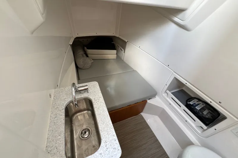 Slide: The Image of Compact cabin interior of 2026 Solace 32CS boat with sink and bed. - 25