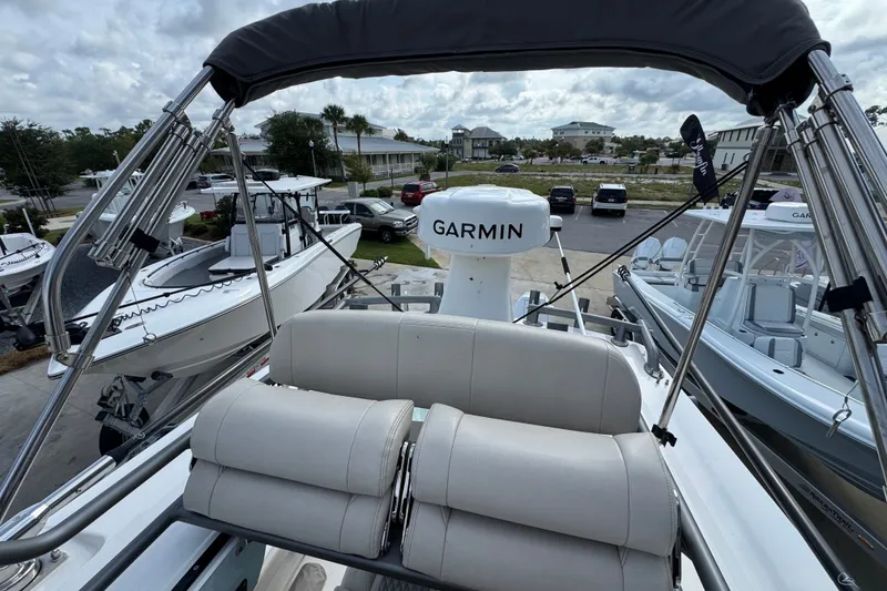 Slide: The Image of 2026 Solace 32CS boat with Garmin equipment, docked among other boats under cloudy skies. - 27